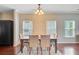 Elegant dining room featuring a wooden table with seating and natural light at 492 Sanders Farm Ln, Wando, SC 29492