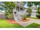 Charming two-story home featuring a welcoming porch with stairs, surrounded by well-maintained landscaping at 492 Sanders Farm Ln, Wando, SC 29492