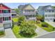 Attractive two-story home showcasing a lush front yard, a ground-level garage, and desirable curb appeal at 492 Sanders Farm Ln, Wando, SC 29492