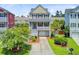 Inviting two-story home with a ground-level garage, landscaped front yard, and appealing curb appeal at 492 Sanders Farm Ln, Wando, SC 29492