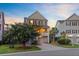 Beautifully landscaped home with manicured lawn, blooming tree, and warm exterior lights, perfect for a serene setting at 492 Sanders Farm Ln, Wando, SC 29492