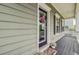 Charming front porch features a decorative wreath, black shutters, and a welcoming 'home' doormat at 492 Sanders Farm Ln, Wando, SC 29492