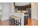 Stylish kitchen with dark cabinetry, stainless steel appliances, and bar stool seating at 492 Sanders Farm Ln, Wando, SC 29492