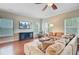 Inviting living room features a plush sectional sofa, ceiling fan, and a wall-mounted TV at 492 Sanders Farm Ln, Wando, SC 29492