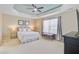 Spacious main bedroom features a decorative tray ceiling, neutral colors, and bright windows at 492 Sanders Farm Ln, Wando, SC 29492