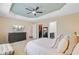 Spacious main bedroom with tray ceiling, television, ensuite bath and walk-in closet at 492 Sanders Farm Ln, Wando, SC 29492