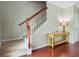 Entry staircase featuring wood handrail, white spindles, and access to the upper level at 492 Sanders Farm Ln, Wando, SC 29492