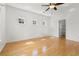 Sun-filled bedroom features hardwood floors, three windows, and a door to the ensuite bathroom at 504 Dolphin Dr, Summerville, SC 29485