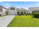 Charming yellow two-story home with a well-manicured lawn, attached garage, and welcoming front porch at 504 Dolphin Dr, Summerville, SC 29485