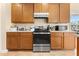 A well-lit kitchen featuring wood cabinets and stainless steel appliances at 504 Dolphin Dr, Summerville, SC 29485