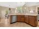 Kitchen view featuring wood cabinets and stainless steel dishwasher open to dining area at 504 Dolphin Dr, Summerville, SC 29485
