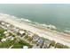 Aerial view of beach houses lining the coastline, with direct beach access and ocean views at 505 E Arctic Ave, Folly Beach, SC 29439