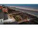 House with a wooden deck backyard overlooking the beach, dune vegetation and scenic ocean views at 505 E Arctic Ave, Folly Beach, SC 29439