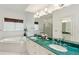 Bathroom features a soaking tub, double sinks, marble countertop, and plenty of natural light at 505 E Arctic Ave, Folly Beach, SC 29439