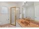 Bright bathroom featuring a glass enclosed shower, and a stylish vanity with pink marble countertop at 505 E Arctic Ave, Folly Beach, SC 29439