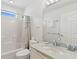 Bathroom with white walls, a single sink vanity, and a bathtub-shower combo with shower curtain at 505 E Arctic Ave, Folly Beach, SC 29439