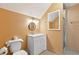 Bathroom featuring peach colored walls, a white vanity, and shower with glass doors at 505 E Arctic Ave, Folly Beach, SC 29439