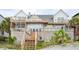 View of the multiple levels of decks with stairs to the ground, accessible from the home at 505 E Arctic Ave, Folly Beach, SC 29439