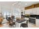 Open-concept kitchen and dining area with island seating, modern appliances, and ocean views at 505 E Arctic Ave, Folly Beach, SC 29439