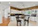 Beautiful kitchen with granite countertops, white cabinets, and a center island with bar stools at 505 E Arctic Ave, Folly Beach, SC 29439