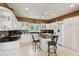 Stylish kitchen boasts white cabinets, granite countertops, stainless appliances, and an island with seating at 505 E Arctic Ave, Folly Beach, SC 29439