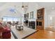 Cozy living room with vaulted ceiling, fireplace, and ocean views at 505 E Arctic Ave, Folly Beach, SC 29439