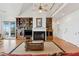 Spacious living room features a fireplace, built-in shelves, hardwood floors, and lots of natural light at 505 E Arctic Ave, Folly Beach, SC 29439