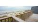 Ocean view from wood deck with rails showing the pier and beach at 505 E Arctic Ave, Folly Beach, SC 29439