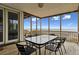 Enjoy the ocean view on the covered porch, complete with a dining table and black chairs at 505 E Arctic Ave, Folly Beach, SC 29439