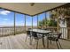 View of the screened in porch with a dining table overlooking the ocean at 505 E Arctic Ave, Folly Beach, SC 29439