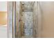 Shower with neutral stone style tilework and a glass door at 505 E Arctic Ave, Folly Beach, SC 29439