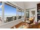 Bright sun room with ocean view features large windows and comfortable seating at 505 E Arctic Ave, Folly Beach, SC 29439