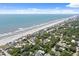 Stunning aerial view of beach homes lining the coast with sandy shore and ocean waves at 509 E Ashley Ave, Folly Beach, SC 29439
