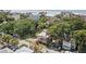 Aerial view of a two-story pink house near the beach and lush greenery at 509 E Ashley Ave, Folly Beach, SC 29439