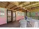 Inviting covered back porch with wood floors and ample seating at 509 E Ashley Ave, Folly Beach, SC 29439