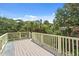 View from the spacious balcony overlooking the surrounding greenery and neighborhood at 509 E Ashley Ave, Folly Beach, SC 29439
