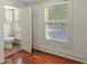 Bathroom featuring a toilet and window, alongside hardwood floors at 509 E Ashley Ave, Folly Beach, SC 29439
