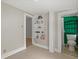 View of a room featuring built-in shelving, access to another room, and an adjacent bathroom at 509 E Ashley Ave, Folly Beach, SC 29439