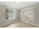 Bright bedroom with natural light, neutral tones, and sunroom access with large windows at 509 E Ashley Ave, Folly Beach, SC 29439