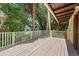 A spacious deck with beige floors, white railings, and a lush, tropical background at 509 E Ashley Ave, Folly Beach, SC 29439
