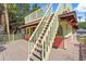 A colorful deck with staircase, light-pink siding, tan trim, and an outdoor seating area at 509 E Ashley Ave, Folly Beach, SC 29439