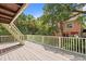 A spacious deck with beige floors, white railings, and a lush, tropical background at 509 E Ashley Ave, Folly Beach, SC 29439