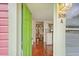 Entryway featuring gleaming wood floors, a vibrant green door, and bright interior at 509 E Ashley Ave, Folly Beach, SC 29439