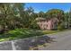 Street view of pink two-story house with green trim and lush landscaping, with trees at 509 E Ashley Ave, Folly Beach, SC 29439