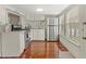 Sunlit kitchen features stainless steel fridge, modern appliances, and hardwood floors at 509 E Ashley Ave, Folly Beach, SC 29439