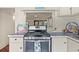 Kitchen with a gas range, white cabinets, and an ocean view at 509 E Ashley Ave, Folly Beach, SC 29439