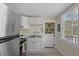 A well-lit kitchen with stainless steel appliances, white cabinets, and a bright window at 509 E Ashley Ave, Folly Beach, SC 29439