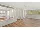 Bright living room featuring hardwood floors, multiple windows, and built-in features at 509 E Ashley Ave, Folly Beach, SC 29439