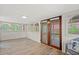 Bright sunroom with vinyl floors, white walls, and large windows offering natural light at 509 E Ashley Ave, Folly Beach, SC 29439