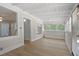 Inviting sunroom with ample windows, wood floors, and white walls at 509 E Ashley Ave, Folly Beach, SC 29439